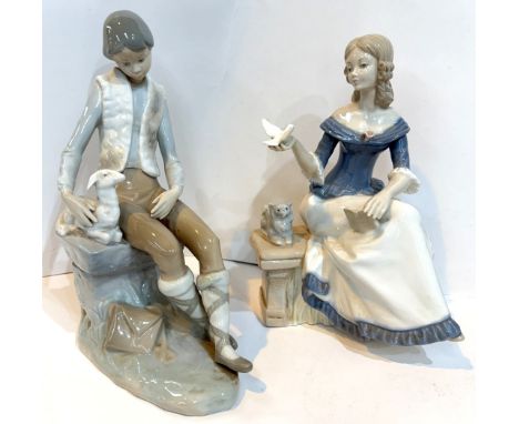 Two Nao figures of girl with puppy, boy with lamb and a similar girl with dove.
