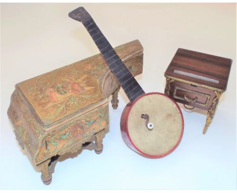 Three late 19th/early 20th century novelty musical boxes:A Manoville in the form of a banjo, with red stained body; a polychr