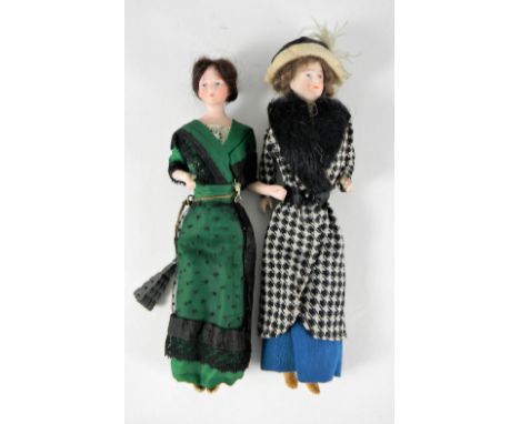 Pair of miniature bisque Edwardian lady dolls in original costumes, German circa 1910, each with finely painted features, wig