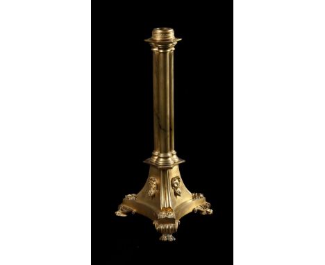 A LATE REGENCY GILT BRASS LAMP BASE IN THE MANNER OF BULLOCK, CIRCA 1820 Cluster column stem, swept base with 'River God' sty
