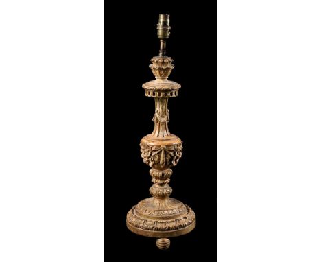 A CONTINENTAL CARVED GILTWOOD LAMP BASE 19TH CENTURY AND LATER Leaf, swag and foliate banded stem, ring turned ball feet the 