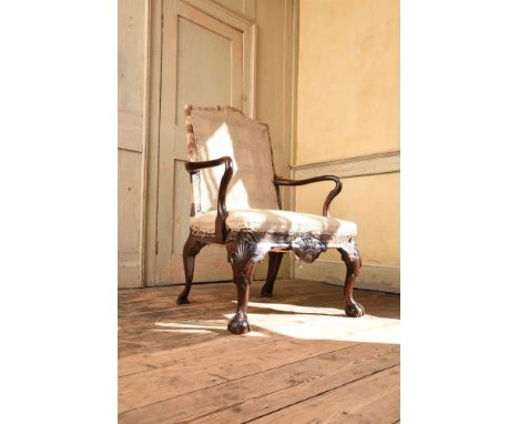 A GEORGE II CARVED WALNUT OPEN ARMCHAIR ATTRIBUTED TO JAMES MOORE, CIRCA 1730 106.5cm high, 69cm wide, 66cm deep overall Prov