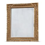 A CARVED GILTWOOD AND GESSO MIRRORIN GEORGE II STYLE