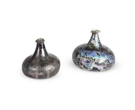 TWO 'ONION' SHAPE WINE BOTTLES ENGLISH, EARLY 18TH CENTURY First with iridescence from burial, string rim   13.4cm high Secon