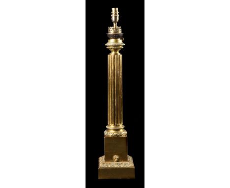 A GILT BRASS LAMP BASESECOND QUARTER 19TH CENTURYConverted oil lamp top on fluted acorn and leaf banded column, square plinth