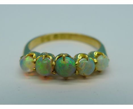 An 18ct gold, five stone opal ring, 2.6g, L