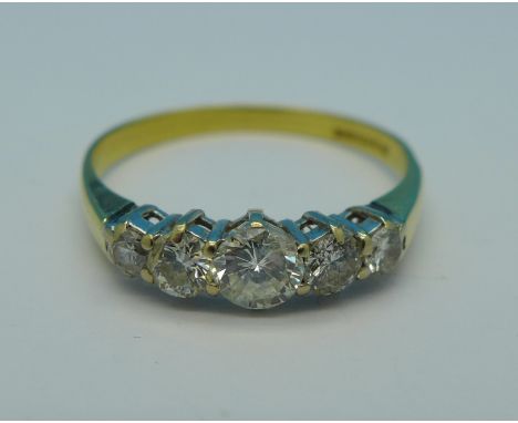 An 18ct gold and five stone diamond ring, centre stone approximately 0.4 carat diamond weight, 2.6g, R