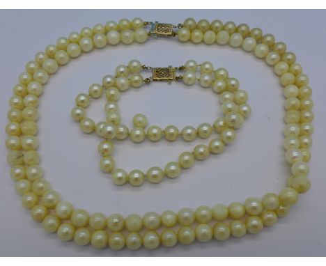 A pearl necklace and bracelet with 14k clasps