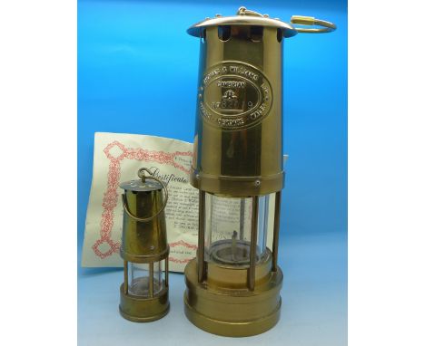 Two brass miners lamps; comprising E. Thomas & Williams Cambrian and a miniature Eccles protector lamp