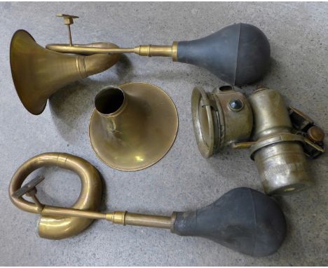 Two brass car horns, one a/f and a motorcycle lamp