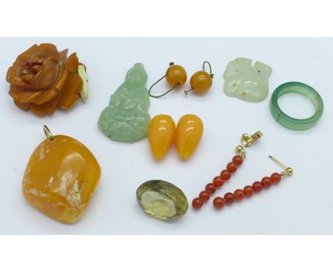 A carved jade Buddha, a pair of earrings, amber, etc.