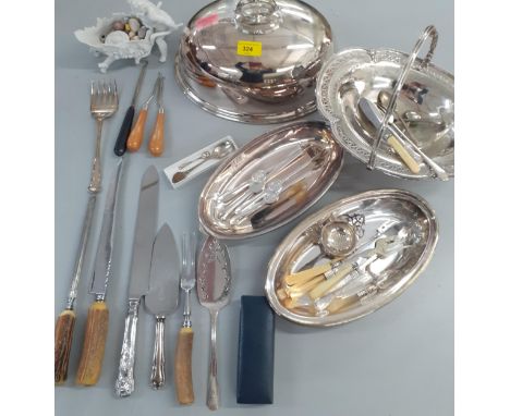 Mixed silver plate to include a meat dome, a bone handled serving set and a Continental white glazed model of a cherub pushin