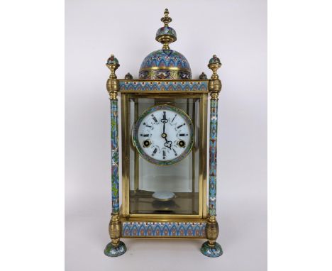 A late 20th century cloisonné and brass mantle clock, the case of architectural design a domed top with turned finial, the fo
