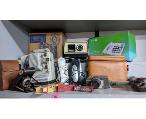 A mixed lot of vintage film and movie cameras, projectors, and accessories to include a Kodak Brownie folding camera in leath