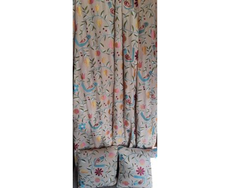A pair of modern G.P &amp; J. Baker embroidered curtains with images of birds, leaves and flora in m multi-colours on a beige