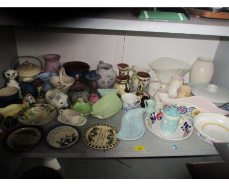 A selection of Devonware motto ware, Art Deco ceramics to include Poole pottery, Wade, and others, along with later table chi