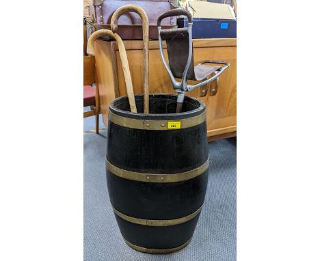 A 19th century brass bound barrel stick stand, 61cm h x 321cm w, together with a shooting stick and two walking sticksLocatio