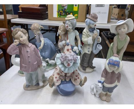 A collection of Lladro figures to include a Society Collection figure of a clown with a lady and dogs, together with a Nao fi