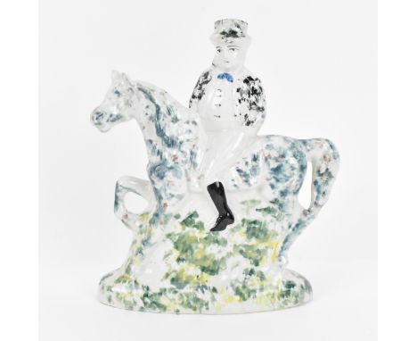 An early 19th century Staffordshire or Yorkshire pearlware model of a rider astride his horse, circa 1810, with sponge decora