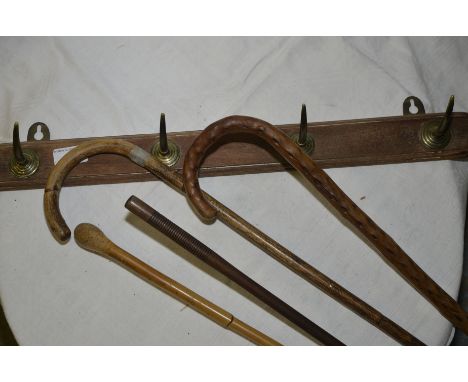 Four pronged coat rack, walking stick and a gun cleaner