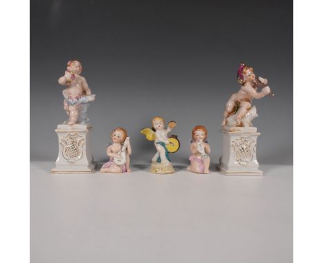 Delightful set of five porcelain cherub figurines, each finely crafted with intricate hand-painted details and delicate gilt 