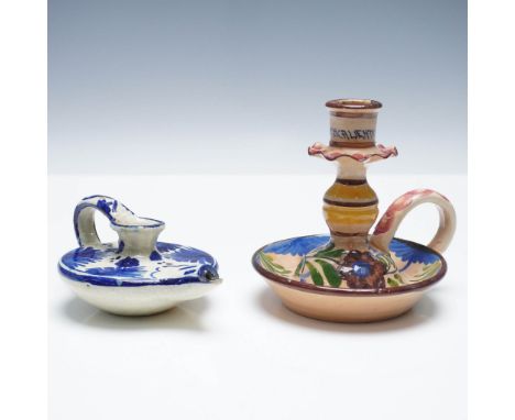 Grouping of two ceramic chambersticks, each with integrated handles and hand-painted floral decoration. The first piece is a 