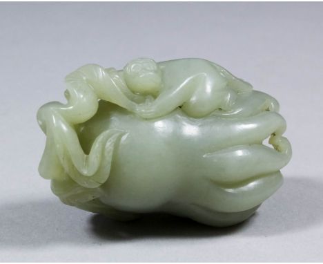 A Chinese pale green jade carving of a finger citron and monkey, 2.5ins (53mm)