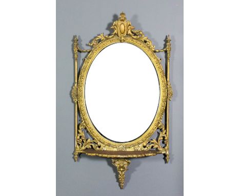 A 19th Century French gilt framed oval wall mirror with moulded leaf and cartouche cresting, floral capped cylindrical uprigh
