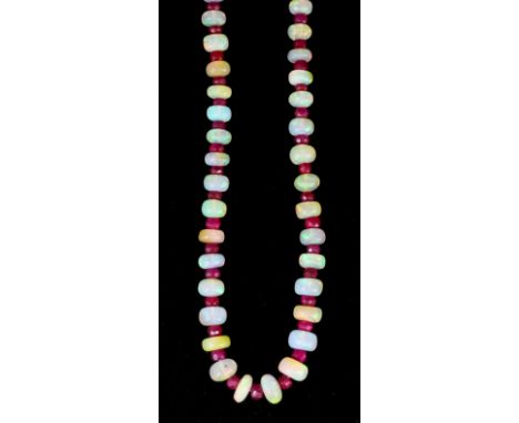 A 20th Century single strand of graduated opal beads interspersed by small facet cut ruby beads, 455mm overall (gross weight 