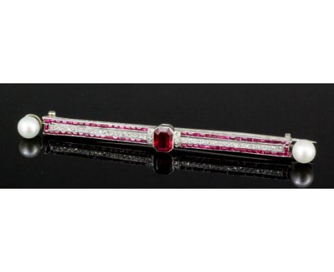 A 1920s platinum mounted ruby, diamond and pearl set bar brooch, the face set with an emerald cut ruby approximately .45ct se