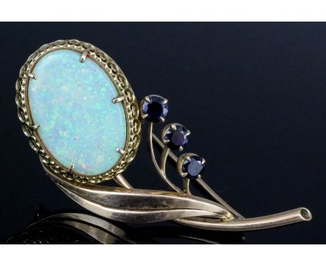 A 1960s gold coloured metal mounted opal and sapphire flowerhead pattern brooch, the oval cut opal approximately 25mm x 18mm 