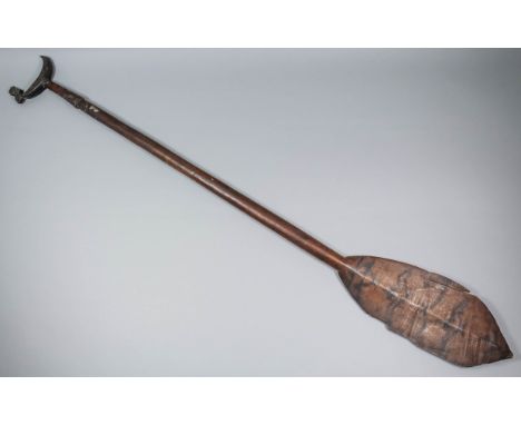 A 19th Century Solomon Islands hardwood canoe paddle, the leaf-shaped blade painted in natural black pigment with birds, the 