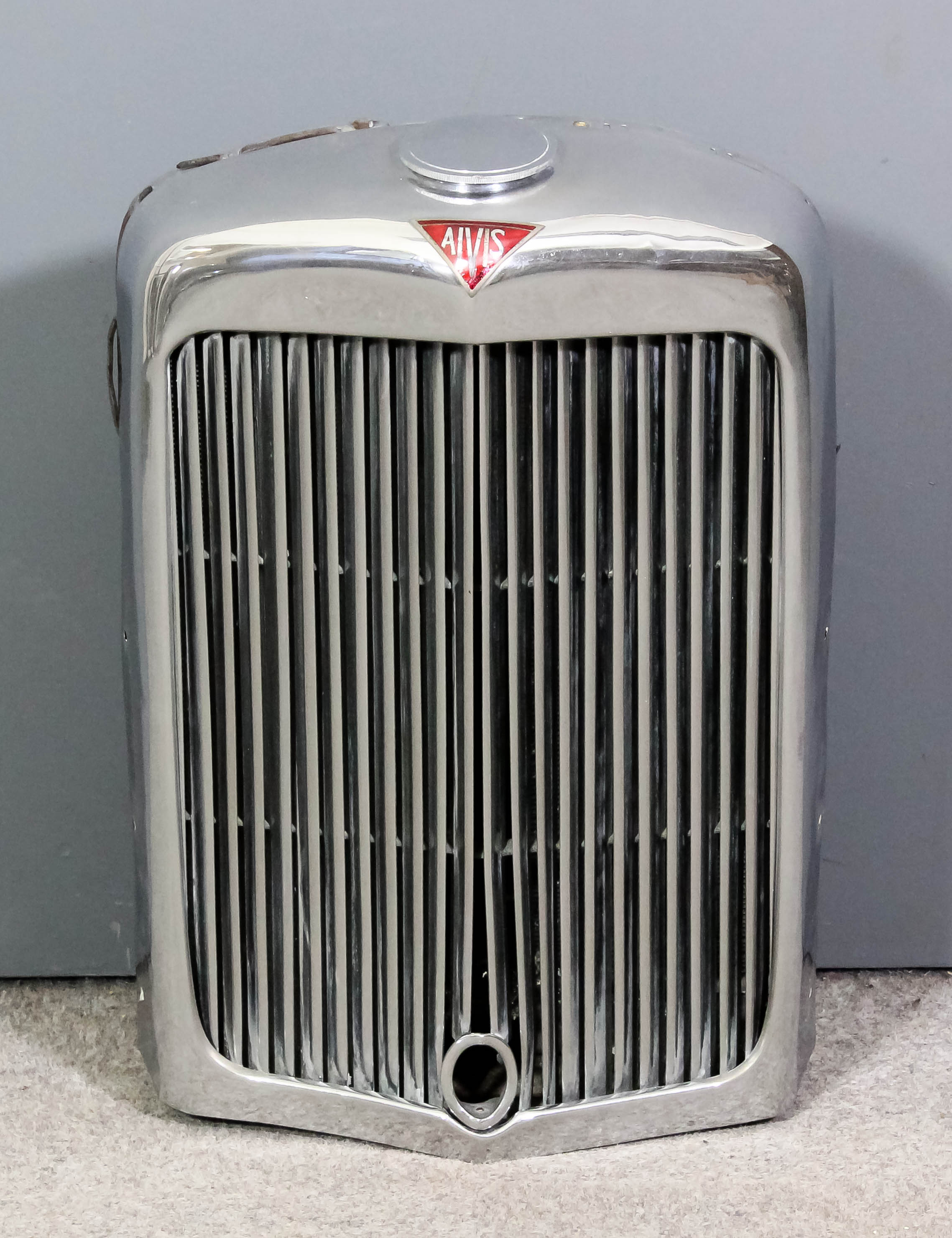 A 1940's Alvis radiator and cap with grille, the radiator with plaque
