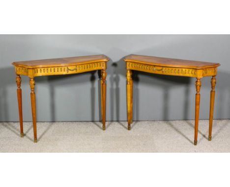 A pair of early 20th Century French gilt metal mounted beechwood and kingwood veneered serpentine fronted console tables, eac