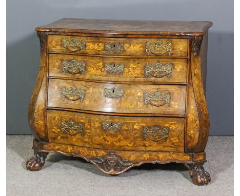 A late 18th/ early 19th century Dutch walnut and marquetry commode of bombe outline, inlaid throughout with leaf scroll and u