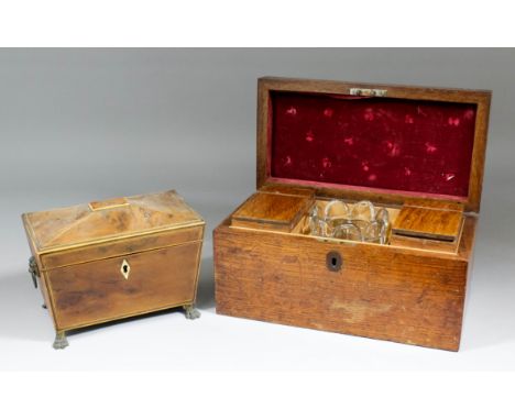 An early 19th Century yewwood two division tea caddy of sarcophagus shape with lion mark carrying handles and lion paw feet, 