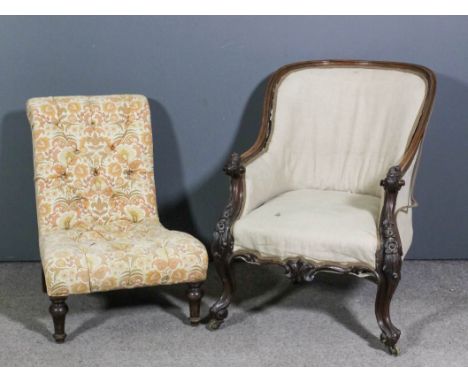 A Victorian rosewood showwood framed spoon backed easy chair with carved and scrolled arm terminals, upholstered in grey cali