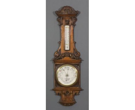 A late 19th Century oak cased aneroid barometer and thermometer retailed by W. Gregory & Co, 51 Strand, London, with 7.5ins d