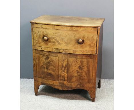 A George III mahogany bow-front night commode, the lifting top with dummy drawer front, dummy doors under with shaped apron, 