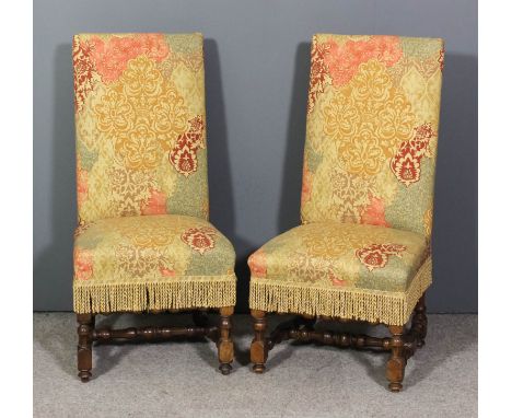 A pair of 19th Century oak high square back dining room chairs, the seats and backs upholstered in tapestry and fringe, on tu