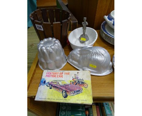 Pottery jelly mould, two tin jelly moulds, small wooden planter, small metallic presentation military figurine and Brooke Bon