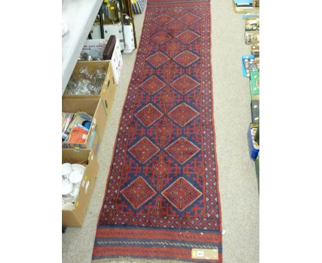 Meshwani carpet runner, red and blue ground with repeating diamond central pattern and single border, 274 x 64 cms