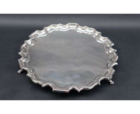 A George VI silver salver with "Chippendale" inspired edge, on three scrolling feet, made for Harrods Ltd, London, 1938, 26.5