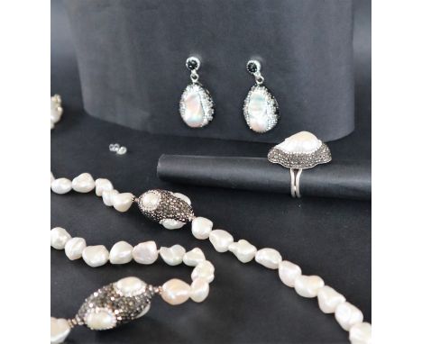 A pearl and paste set necklace, earrings, and ring set, with irregular pearls to a silver setting