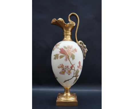 A Royal Worcester ewer with a mask handle, decorated with flowers and leaves on a square pedestal foot, puce mark, 26.5cm hig