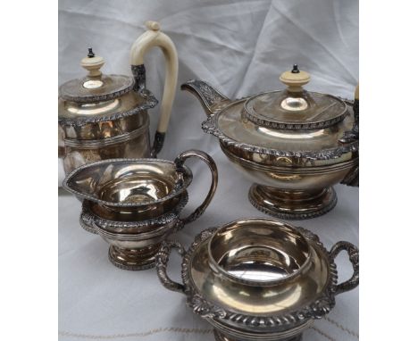 An Elizabeth II silver four piece tea set, comprising a flattened teapot, hot water jug, cream jug, and sugar basin, decorate