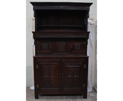 An 18th century oak Tridarn, the top section with a moulded cornice and shelf, the mid section with two cupboards and a centr