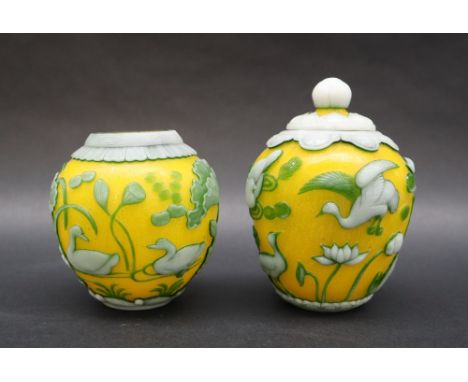 A pair of Chinese overlay jars and cover, with a yellow ground, carp fisherman, ducks etc, seal mark to the base 12cm high 