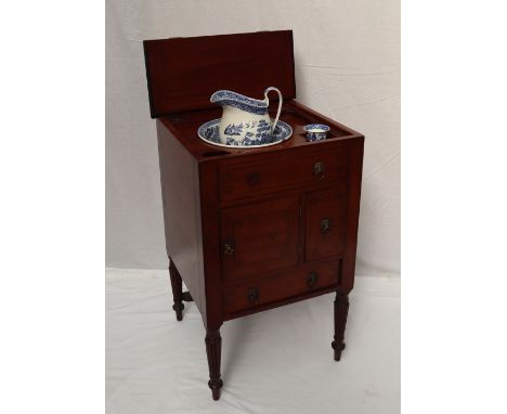 A William IV mahogany gentleman's washstand, the rectangular hinged square top enclosing a rise and fall mirror, central well