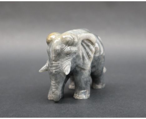 A jade carved elephant, in mottled grey and green, 8cm wide x 6.5cm high 